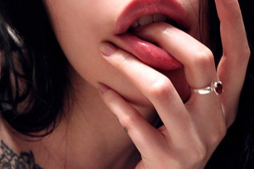 a hot girl sucking her finger